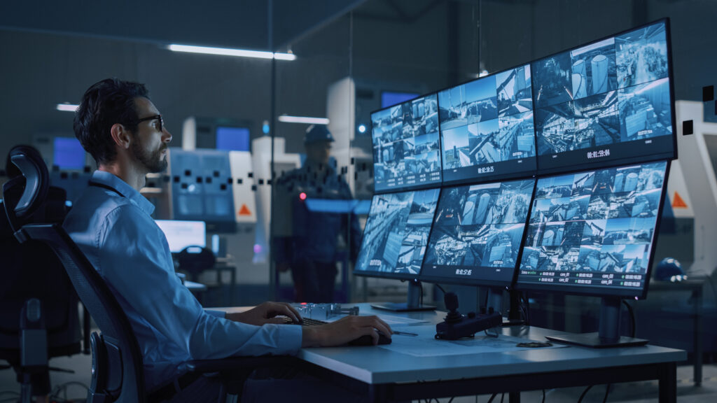 Inneos | Optics vs Copper: Debunking Myths and Understanding the Real Benefits Man sitting in front of security screens.