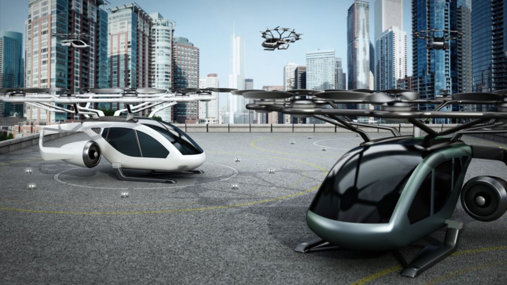 Inneos | Exploring the Hidden Benefits of Using Fiber Cables in Electric Aircraft Conceptual rendering of eVTOL (electric vertical take-off and landing) aircrafts as a taxi shuttle service at the helipad on top of a building.
